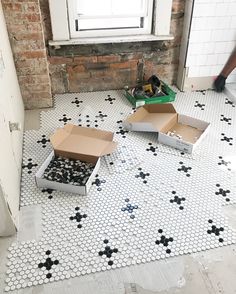 two open boxes sitting on top of a tiled floor