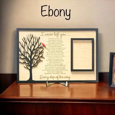 a wooden frame with a tree and poem on it