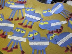 a wooden table topped with lots of blue paper cut outs