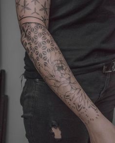 a man with a flower tattoo on his arm