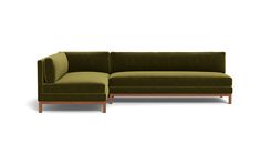 a green sectional couch sitting on top of a white floor next to a wooden frame