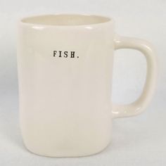 a white coffee mug with the word fish written on it's front and bottom