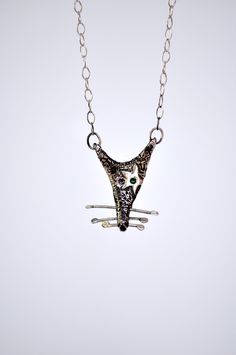 Embrace the unconventional with our Rat Necklace, a whimsical and quirky piece of handmade jewelry that celebrates the unique charm of these often misunderstood creatures. 🐀💫 Crafted with care and attention to detail, this silver necklace features a black patina rat head pendant, exuding an aura of mystery and intrigue. 🖤✨ But what sets this necklace apart is the shiny silver star adorning one eye, reminiscent of the iconic style of David Bowie. 🌟⚡️ Whether you're drawn to its quirky design Artsy Sterling Silver Pendant Necklace, Whimsical Necklaces For Gifts, One Of A Kind Whimsical Jewelry As A Gift, Whimsical Artistic Jewelry For Gifts, Whimsical Artistic Design Jewelry For Gift, Whimsical Artistic Design Jewelry Gift, Unique Sterling Silver Necklaces With Artistic Design, Artsy Silver Necklace With Unique Variations, Unique Sterling Silver Necklace With Artistic Design