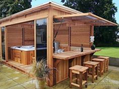 a wooden hot tub sitting next to a picnic table