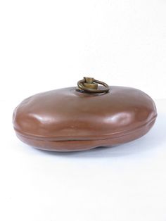 a brown purse sitting on top of a white table