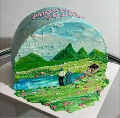 a cake that is decorated to look like a landscape