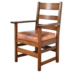 a wooden chair with leather upholstered seat and armrests on an isolated white background