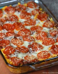 a casserole dish with tomatoes and cheese in it sitting on a table top