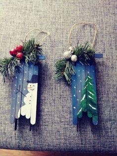 two wooden sleds decorated with christmas decorations