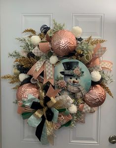 a wreath on the front door decorated with ornaments