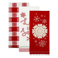 three red and white kitchen towels with snowflakes on them, one in the center