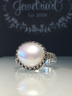 Handmade Pearl Ring. Natural Pearl Ring. Artisan Pearl Ring. Upcycled Pearl Ring. Crown Ring. Unique Pearl Ring. Stunning upcycled pearl and solid sterling silver hand forged medieval ring. Handcrafted with crown bezel and beautifully etched very substantial 10 gauge band. This ring is a size 8 1/2 but can be made to order with a similar pearl🎁🎁 All rings are handmade by me so feel free to contact me with any custom requests. Pearl measures 14mm. Show your Love❤️❤️ on Anniversaries, Birthdays, Heirloom Untreated Jewelry For Anniversary, Hand Forged Fine Jewelry, Artisan Oval Jewelry For Weddings, Heirloom Silver Oval Pearl Ring, Handmade Classic Round Band Ring, Artisan Untreated Jewelry For Wedding, Artisan White Jewelry For Anniversary, Handmade Heirloom White Gold Jewelry, Artisan Oval Wedding Jewelry