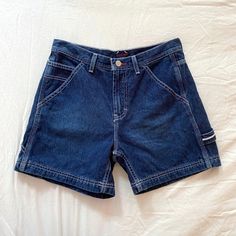 Vintage 90s Y2K dark wash Tommy Jeans Tommy Hilfigir jean shorts. Mid rise fit with carpenter pockets / hammer loop details. Excellent condition. Fits like an XS. Check out the measurements below! Waist: 27" Rise: 10" Length: 14" Inseam: 4" Hips: 36" Tag size: 7 Brand: Tommy Jeans Y2k Denim Blue Jean Shorts With Pockets, Y2k Denim Blue Shorts With Pockets, Y2k Denim Shorts With Pockets, Dark Wash Cargo Pocket Shorts, Dark Wash Jean Shorts With Cargo Pockets, Dark Wash Cargo Shorts, Dark Wash Cargo Jean Shorts, Y2k High Rise Shorts With Pockets, Y2k High-rise Shorts With Pockets