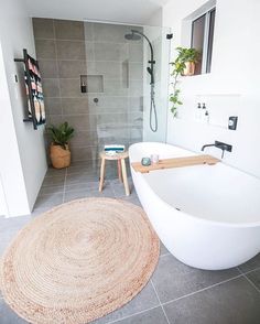 a large white bath tub sitting inside of a bathroom next to a walk in shower