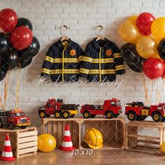 a fireman's birthday party with black, yellow and red balloons on the wall