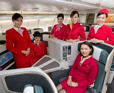 the cabin crew of an airplane posing for a photo