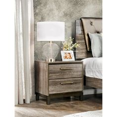 a night stand with two drawers and a lamp