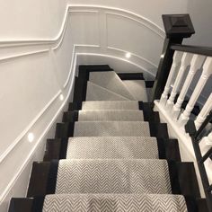 a set of stairs with black and white carpet