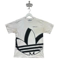 Recommended size: Medium  With discoloration/staining    Great Condition  ★ Era: 2000s MEASUREMENTS: Pit to Pit: 19 in Top to Bottom: 25 in Affordable Adidas Graphic Tee, White Bleached Tops For Streetwear, White Bleached Top For Streetwear, Streetwear Bleached Graphic Tee T-shirt, White Y2k Shirt For Streetwear, White Y2k Style Shirt For Streetwear, Adidas Graphic Tee For Streetwear, 90s Style White Streetwear Shirt, Adidas Top