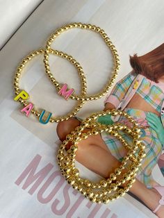 • Gold plated beads • enamel letters • customizable Personalized Letter Beads Bracelets, Trendy Jewelry With Letter Print On Round Beads, Customized Gold Beaded Bracelets, Trendy Gold Charm Bracelet With Letter Beads, 3 Letter, Custom Bracelets, Adele, Made In France, Gold Plate