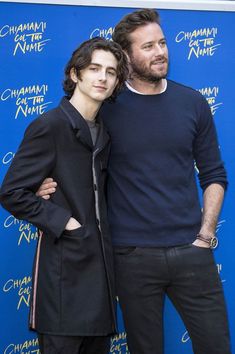 two people standing next to each other on a blue carpet with the words chamau de nime written on it