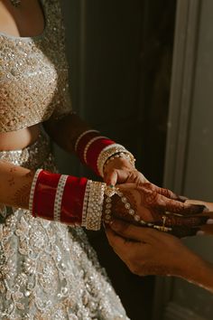 the bride and groom are getting ready for their wedding ceremony to begin, holding each other's hands