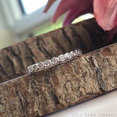 - This dainty eternity band is both beautiful and elegant featuring small bezel set CZ stones. This ring is extremely versatile...perfect for stacking with other small bands as well as wearing alone. Made of solid 925 sterling silver with a high polish finish and an anti-tarnish coating. MATERIALS & MEASUREMENTS ------------------------ - I only use high quality 925 sterling silver materials and components - CZ Stones - 1mm each (bezel set) - Width - 2mm Free shipping on all orders of $35 or White Sterling Silver Stackable Eternity Band, Stackable White Sterling Silver Eternity Band, Adjustable Half Eternity Diamond Band, Stackable Cubic Zirconia Bands As A Gift, Stackable Sterling Silver Eternity Band For Promise, Anniversary Eternity Band With Halo Cubic Zirconia, Cubic Zirconia Halo Eternity Band For Anniversary, Cubic Zirconia Halo Eternity Band Promise Ring, Silver Eternity Band With Halo For Promise