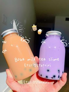 two jars with bubbles in them are being held by someone's hand and the words boba milk teaslime above it