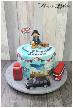 a birthday cake decorated with an image of the british flag and teddy bear on top