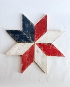 a wooden star is painted red, white and blue