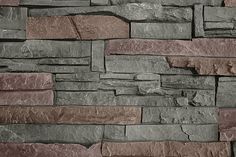 a stone wall with different colors and shapes