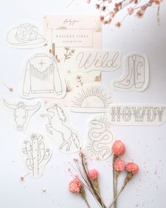 various stickers and flowers on a white surface with dried flowers in the foreground