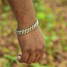 Introducing the Jewels Essence 8" Stainless Steel Cuban Link Chain Bracelet – a symbol of sophistication and enduring style. This masterpiece embodies the essence of modern elegance, seamlessly blending the iconic Cuban link design with the luster of stainless steel. Crafted for both men and women who appreciate the finer things in life, this bracelet is more than an accessory; it's a statement. Specifications: Length: 8 inches, providing a perfect fit for a variety of wrist sizes. Material: Premium-grade Stainless Steel, chosen for its durability and hypoallergenic properties. Gemstone: Adorned with Cubic Zirconia, offering the brilliance of diamonds without the extravagant cost. Closure: Secure Buckle, ensuring that the bracelet remains safely clasped. Chain Style: Curb (Cuban Link), is Silver Diamond Chain Bracelets, White Gold Cuban Link Bracelet With Solid Construction, Silver Diamond Link Bracelet, Adjustable Silver Cuban Link Metal Bracelet, Silver Chain Link Diamond Bracelet For Formal Occasions, Luxury Silver Cuban Link Bracelet With Solid Construction, Modern Silver Diamond Chain Bracelet, Formal Silver Chain Link Diamond Bracelet, Modern Silver Cuban Link Bracelet