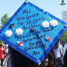 a blue graduation cap with writing on it