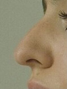 a close up of a woman's nose with long eyelashes