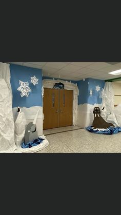 an office decorated for christmas with snowflakes on the walls and decorations around the doors