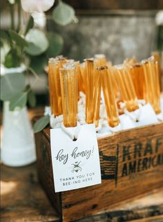 honey sticks are sitting in a wooden crate with tags on them that say, thank you for beeing here