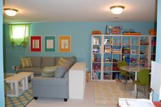 a living room filled with furniture next to a book shelf covered in lots of books