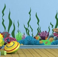 an underwater scene with toys on the floor and seaweeds in the water behind it