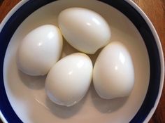 four white eggs in a blue and white bowl