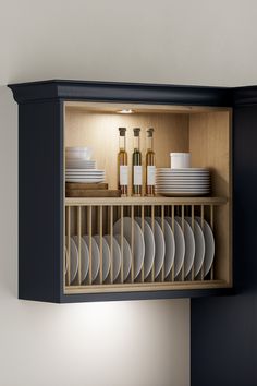 an open cabinet with plates and bottles on it