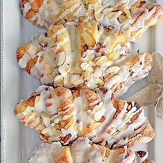 a white plate topped with donuts covered in icing