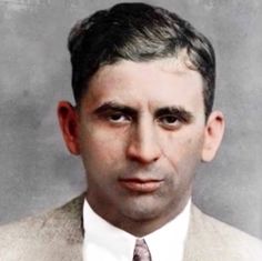 an old photo of a man in a suit and tie with a serious look on his face