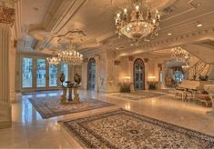 an ornately decorated lobby with chandeliers and large rugs on the floor