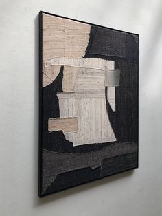 a black and white painting hanging on the wall