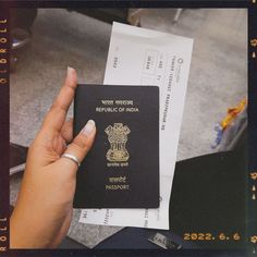 a person holding up a passport in their hand