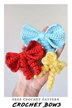 hand holding three crocheted bows in different colors