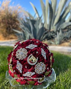 a red bridal bouquet sitting in the grass