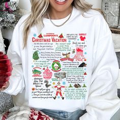 a woman wearing a white christmas vacation sweatshirt with santa clause on the front and other holiday related items around her neck