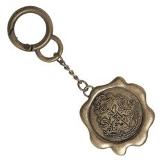 a metal keychain with a coat of arms on it